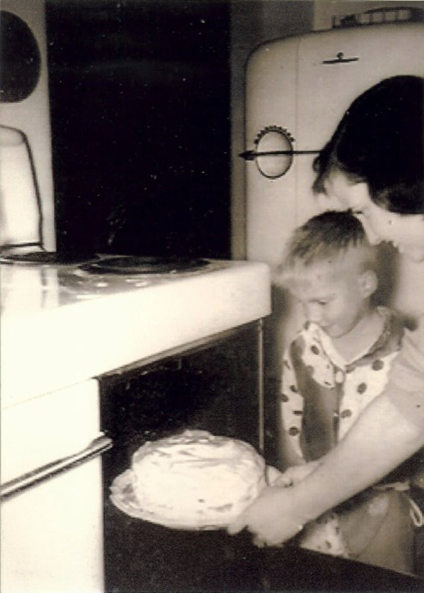 The author's mother with a frosted cake